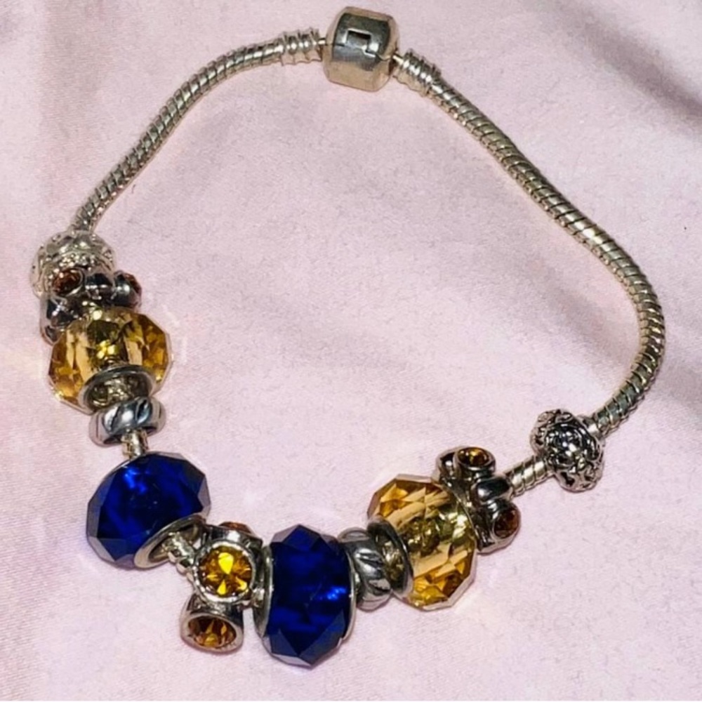 Blue and gold pandora-style charm bracelet.